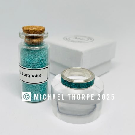 Turquoise embedded ring with option of ashes hidden.